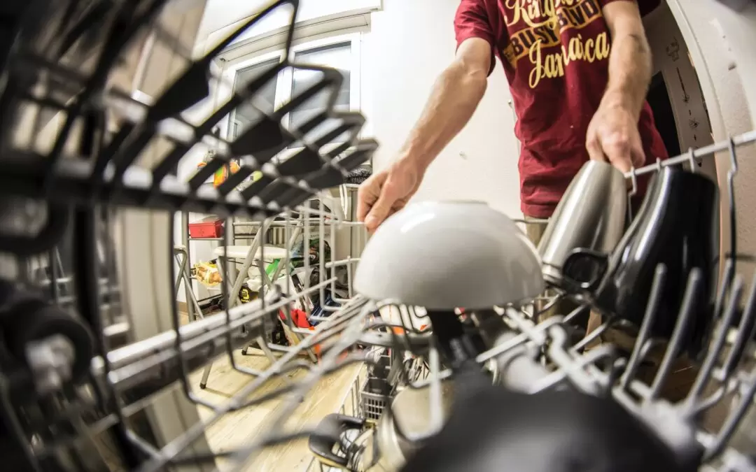 Man putting dishes in dishwasher